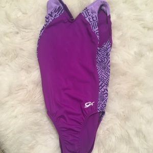 Purple leotard with white gymnastics words